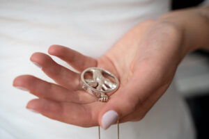 hand holding tree of lives pendant